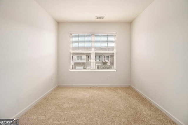 unfurnished room with light colored carpet