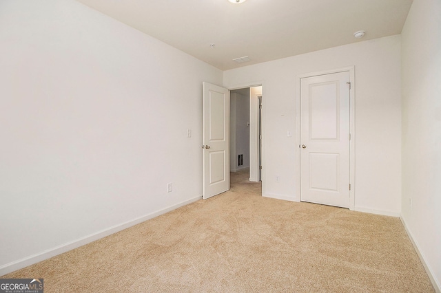 unfurnished bedroom featuring light carpet