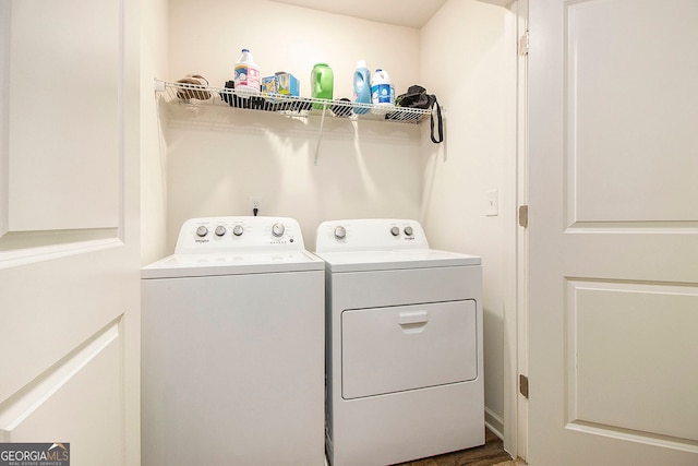 clothes washing area with washer and dryer and wood-type flooring