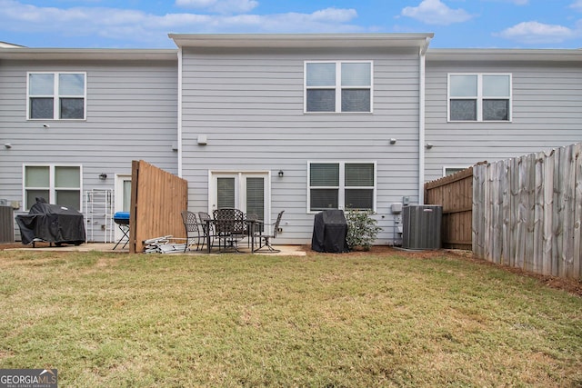 back of property featuring a yard, central AC unit, and a patio area