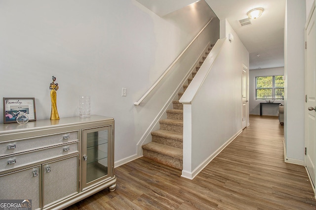 stairs with hardwood / wood-style flooring