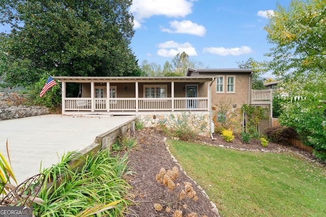 ranch-style home featuring a porch and a front yard