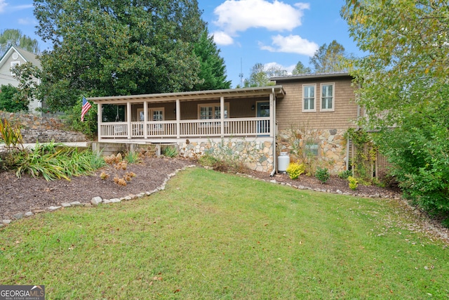 view of front facade featuring covered porch and a front yard