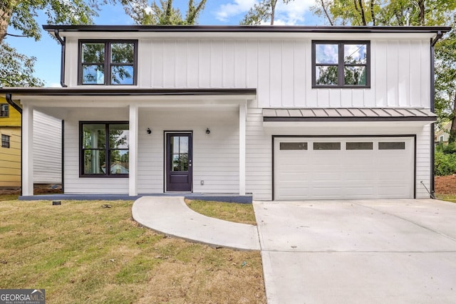 view of front of house with a garage and a front lawn