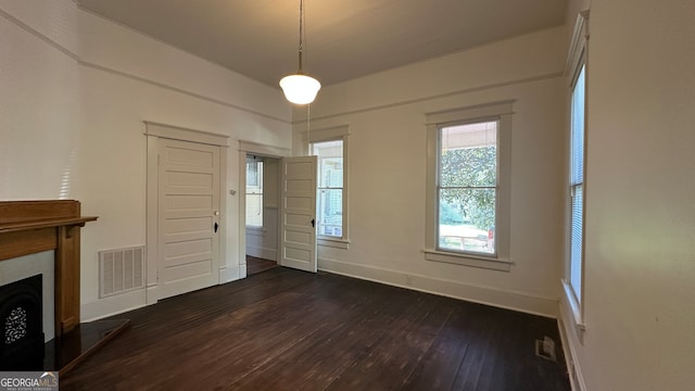 unfurnished living room featuring dark hardwood / wood-style floors