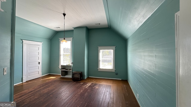 additional living space with dark wood-type flooring and vaulted ceiling