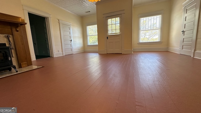 unfurnished living room with crown molding and hardwood / wood-style flooring