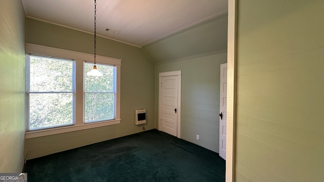 empty room with dark carpet, lofted ceiling, and heating unit