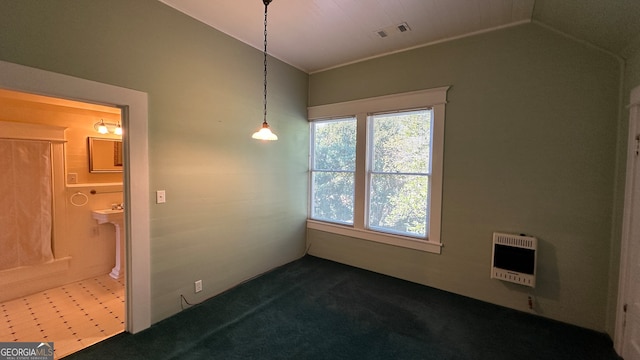 empty room with vaulted ceiling and heating unit