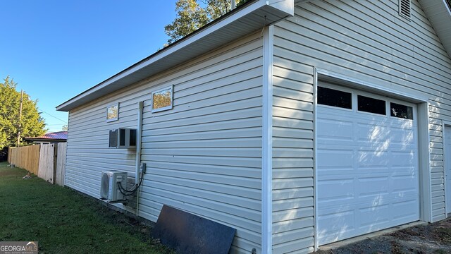 view of property exterior with central air condition unit and a garage