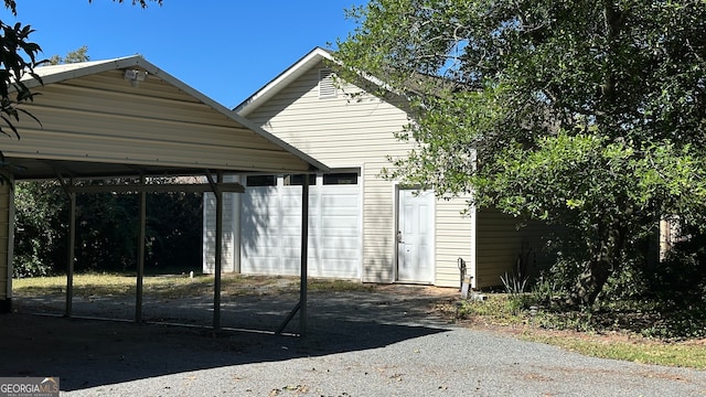 view of outdoor structure featuring a carport and a garage