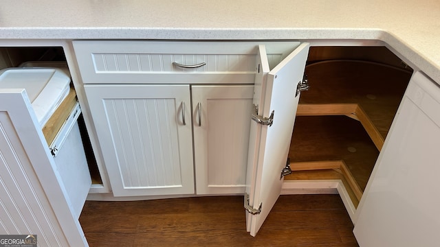 room details with white cabinetry and dark hardwood / wood-style floors