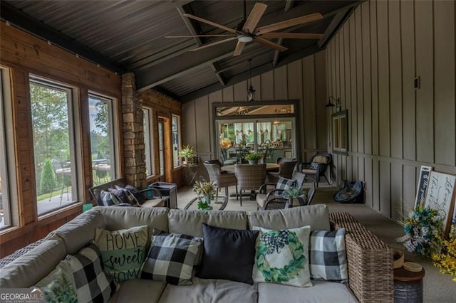 sunroom featuring ceiling fan, lofted ceiling with beams, and wood ceiling