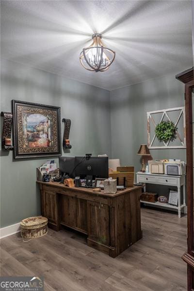 office area with a notable chandelier and hardwood / wood-style flooring