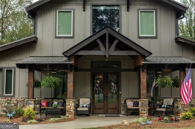 view of exterior entry with french doors and a porch