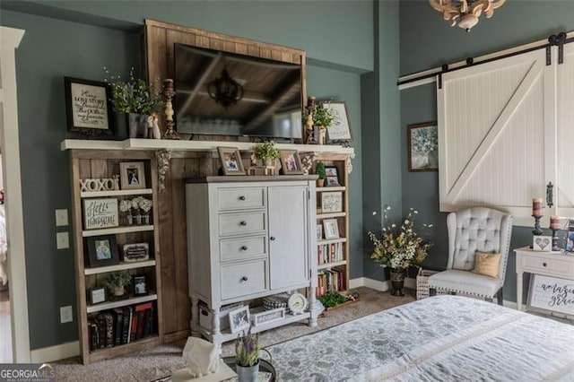 bedroom with carpet and a barn door