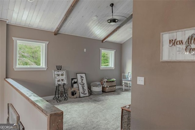 living area featuring wooden ceiling, carpet floors, and vaulted ceiling with beams