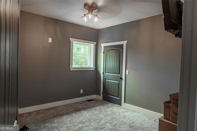 spare room with carpet floors and ceiling fan