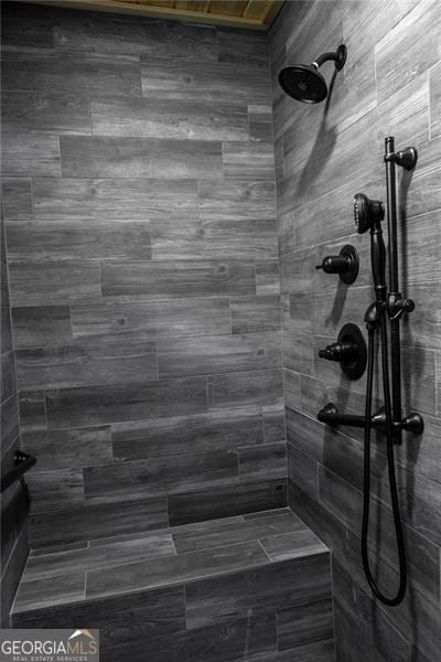 bathroom with tiled shower