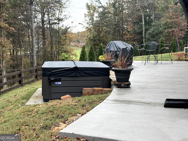 exterior space featuring a patio, a hot tub, and a grill