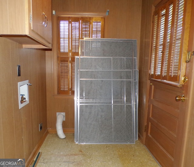 bathroom featuring wooden walls