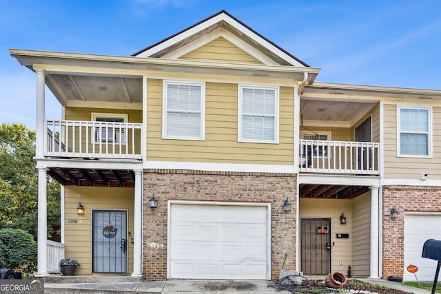 view of front of property featuring a balcony and a garage