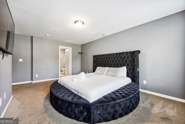 carpeted bedroom featuring connected bathroom