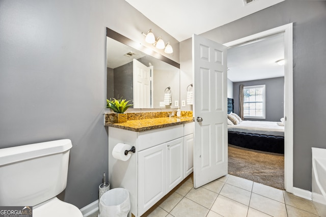 bathroom with tile patterned floors, toilet, and vanity