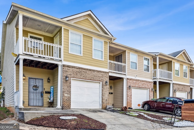 view of property with a garage and a balcony