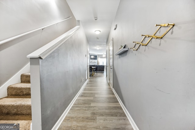 corridor with wood-type flooring