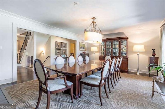 dining space with crown molding and dark hardwood / wood-style floors