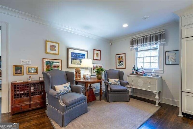 sitting room with dark hardwood / wood-style floors and ornamental molding