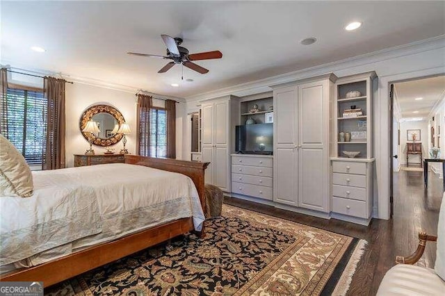 bedroom with crown molding, ceiling fan, and dark hardwood / wood-style floors