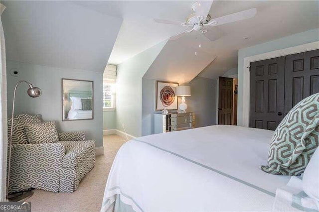 bedroom featuring ceiling fan, light colored carpet, lofted ceiling, and a closet