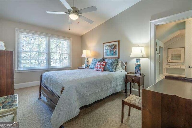 bedroom with ensuite bath, ceiling fan, vaulted ceiling, and carpet flooring