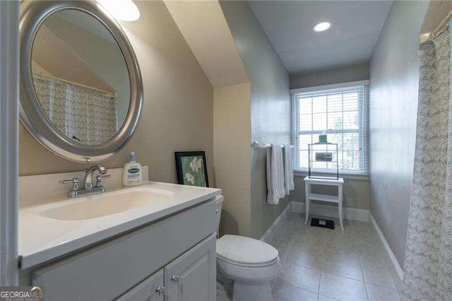 bathroom featuring tile patterned flooring, vanity, and toilet