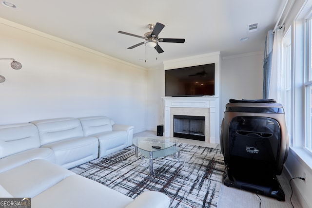 living room featuring ornamental molding and ceiling fan