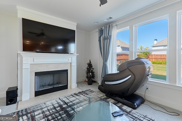 sitting room with ornamental molding, ceiling fan, and a wealth of natural light