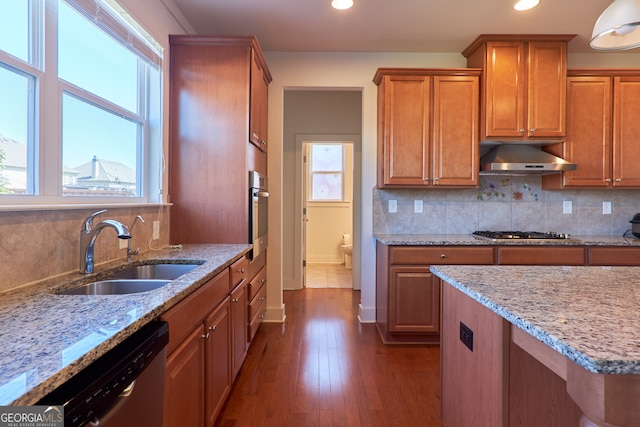 kitchen with stainless steel appliances, dark hardwood / wood-style flooring, a wealth of natural light, and sink