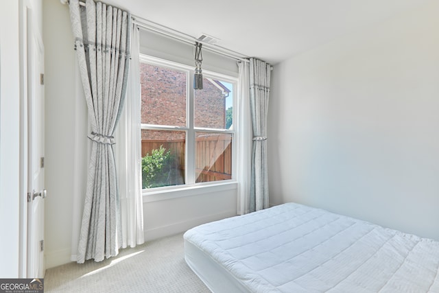 bedroom with light colored carpet