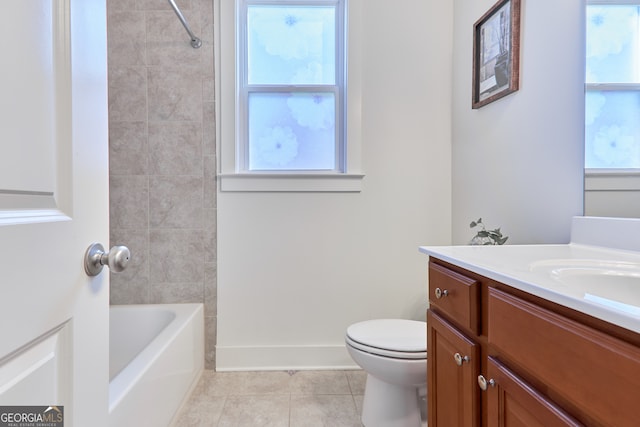 full bathroom with tile patterned flooring, tiled shower / bath combo, vanity, and toilet