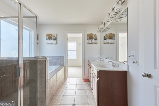 bathroom featuring tile patterned flooring, separate shower and tub, and vanity