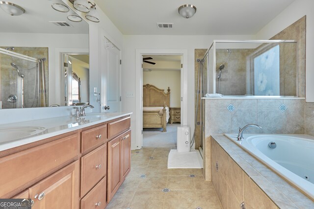 bathroom with tile patterned floors, separate shower and tub, and vanity