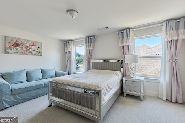 carpeted bedroom featuring multiple windows