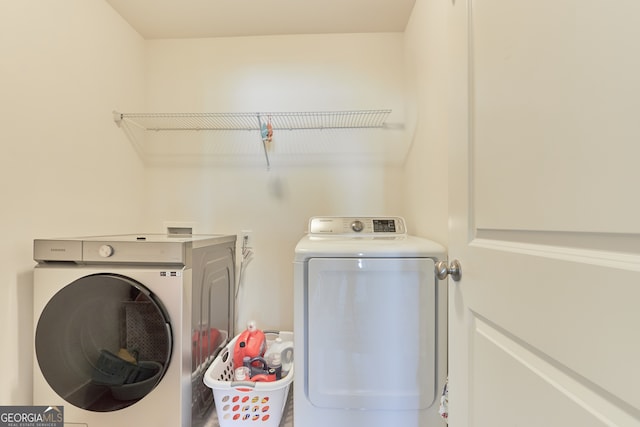 clothes washing area with washing machine and clothes dryer