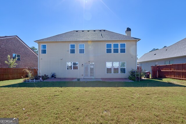 back of house with a yard and a patio area