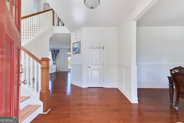 entrance foyer featuring dark hardwood / wood-style floors and ornamental molding