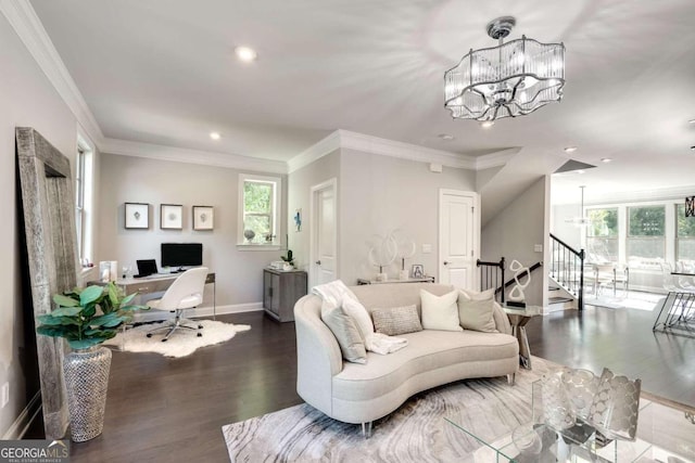 living room featuring an inviting chandelier, hardwood / wood-style flooring, ornamental molding, and a wealth of natural light