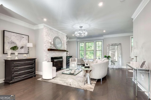 living room with a fireplace, crown molding, dark wood-type flooring, and a chandelier