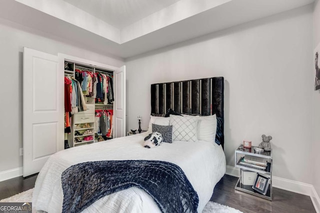 bedroom featuring a closet and dark wood-type flooring